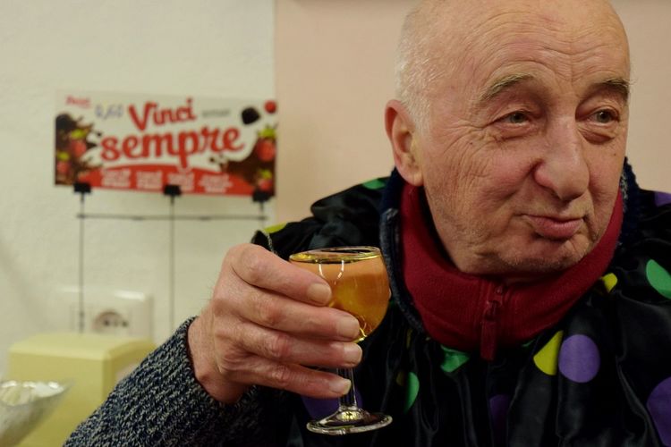 Close-up of senior man holding drink glass