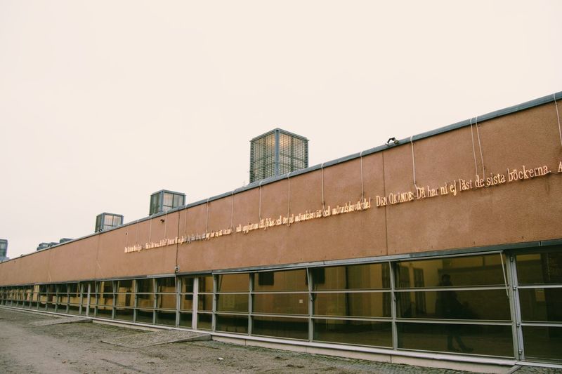 Train against building against clear sky
