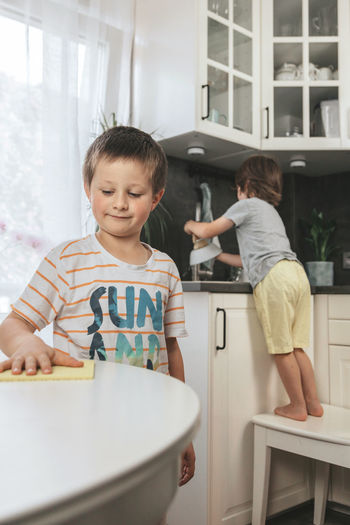 Boy and woman in kitchen at home