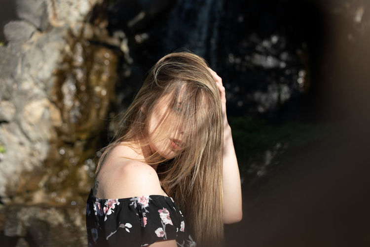 Close-up portrait of young woman standing outdoors
