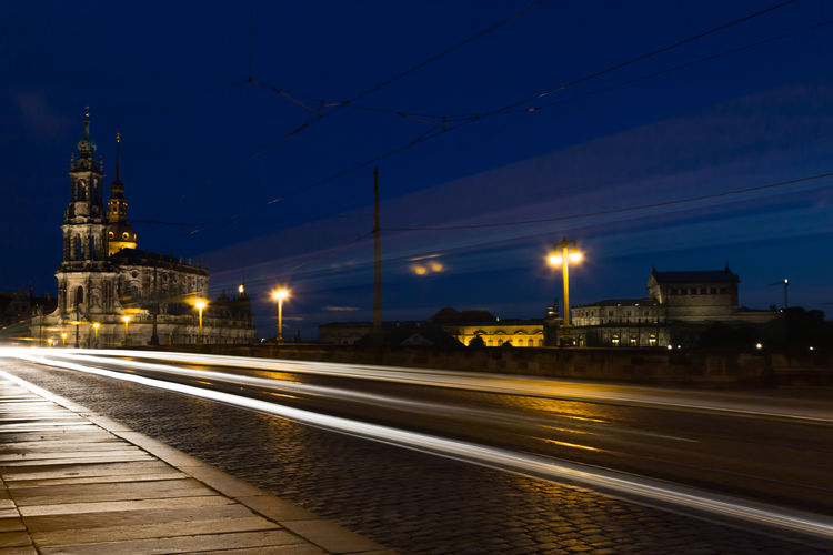 Light trails on road against buildings in city