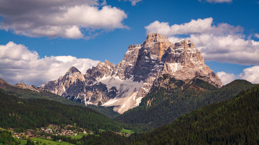 Scenic view of pelmo mountain and selva di cadore on fiorentina valley against sky.