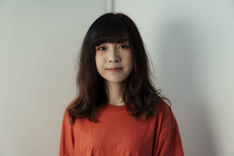 Portrait of sad woman against wall
