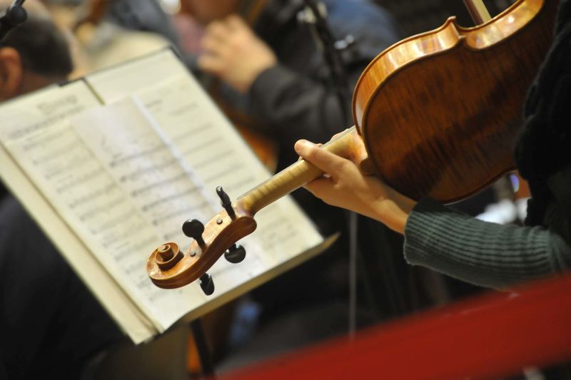 A violinist with violin plays in an orchestra, classical music