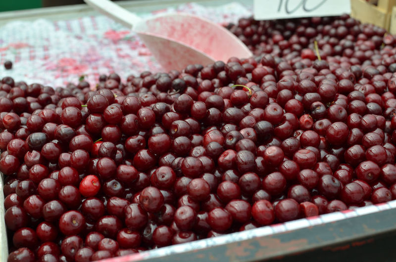Ripe sour cherries on green market desk in spring
