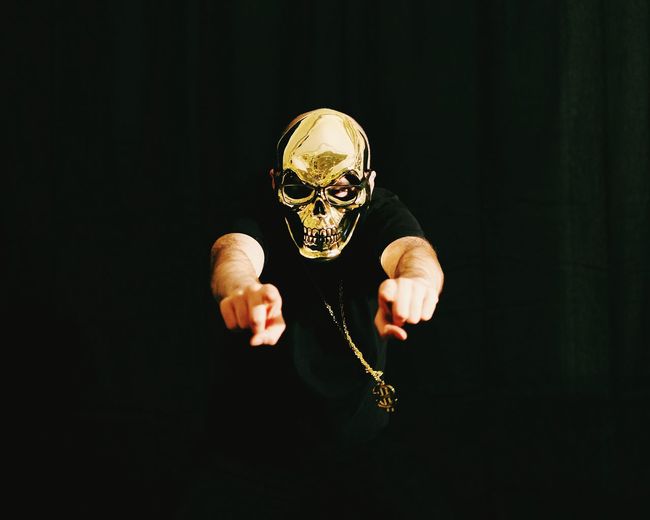 Person wearing gold mask