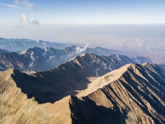 Aerial view of snowcapped mountains against sky