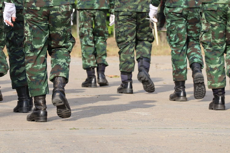 Low section soldiers walking on road