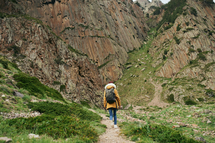 Rear view of woman walking on mountain