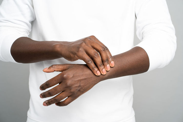 Close-up of man hand against white background