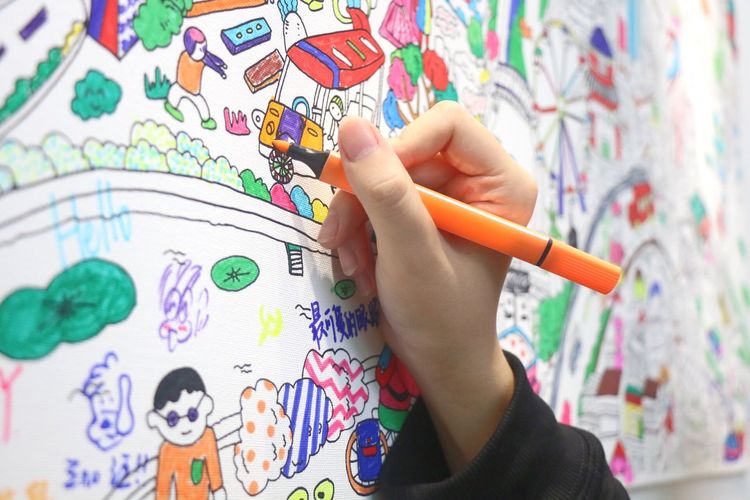 Close-up of hand drawing on whiteboard