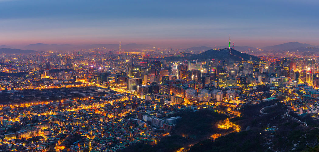 Illuminated cityscape against sky