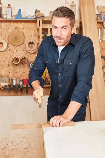 Portrait of smiling carpenter working at workshop