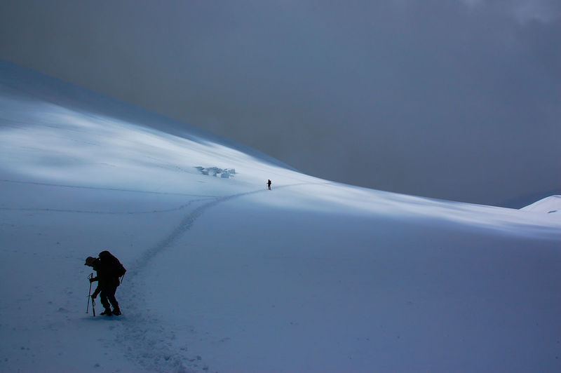 Full length of person on snowcapped mountain against sky