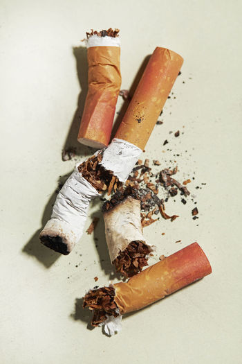 High angle view of cigarette on table against white background