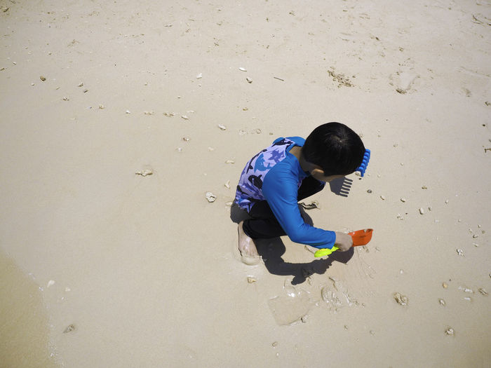 High angle view of boy playing on beach