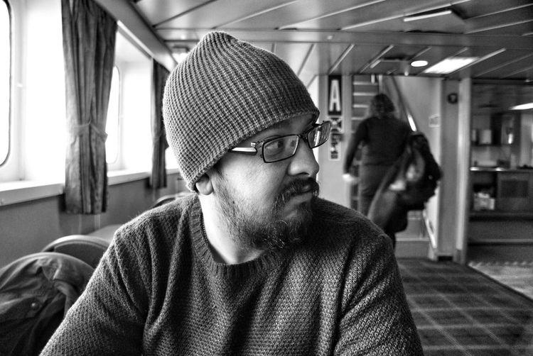 Close-up of man sitting in tourboat