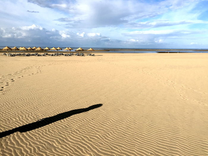 Shadow of person on sandy beach