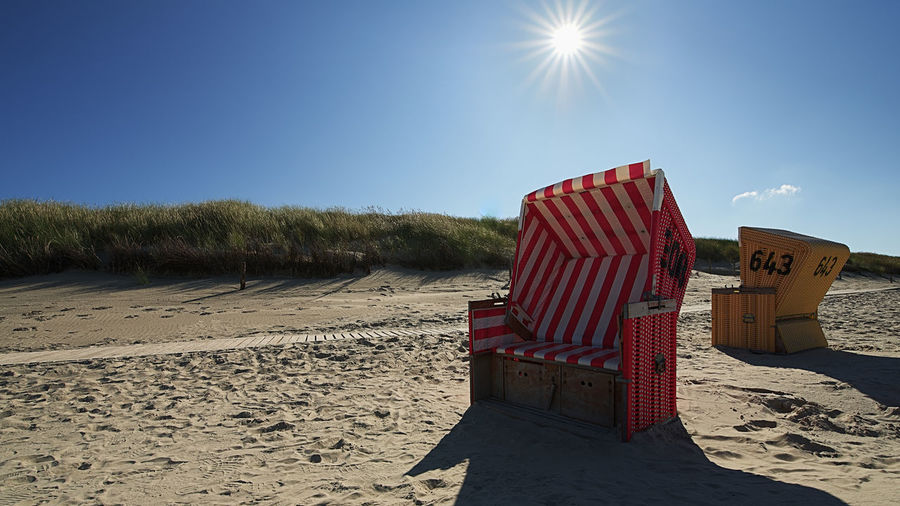 Built structure on beach against clear sky on sunny day
