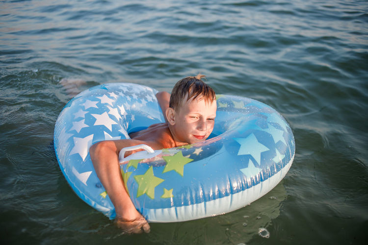 High angle view of boy swimming in sea