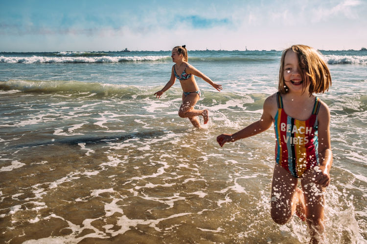 Action shot of girls playing in water on huntington beach