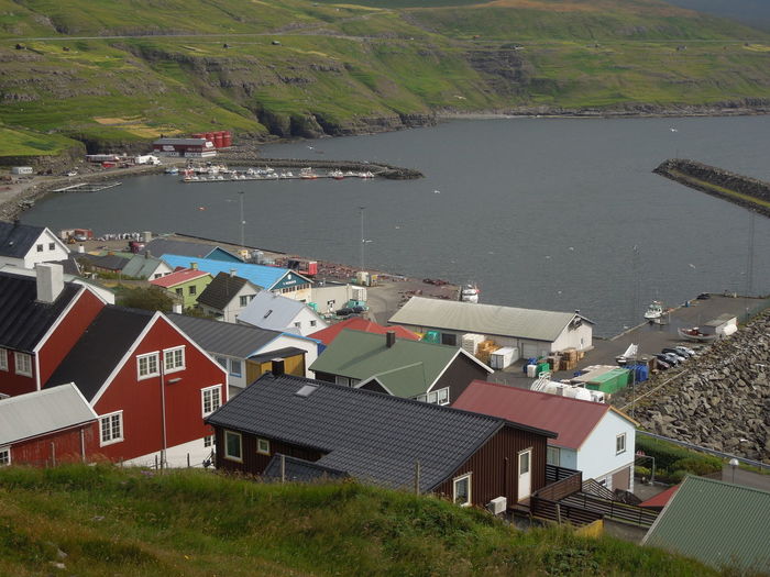 High angle view of houses by sea and town