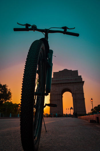 Low angle view of bicycle against clear sky at sunset
