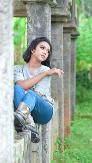 Portrait of smiling young woman sitting outdoors