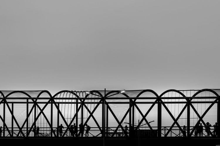 Low angle view of silhouette bridge against sky