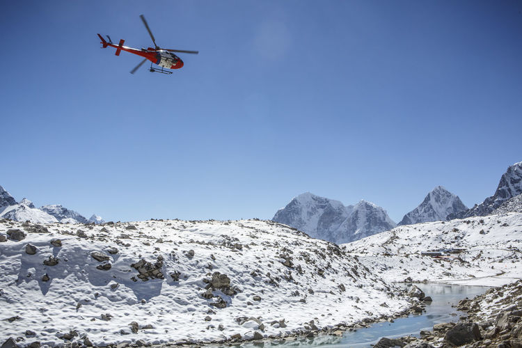 A helicopter approaches a landing pad near mt everest base camp, nepal