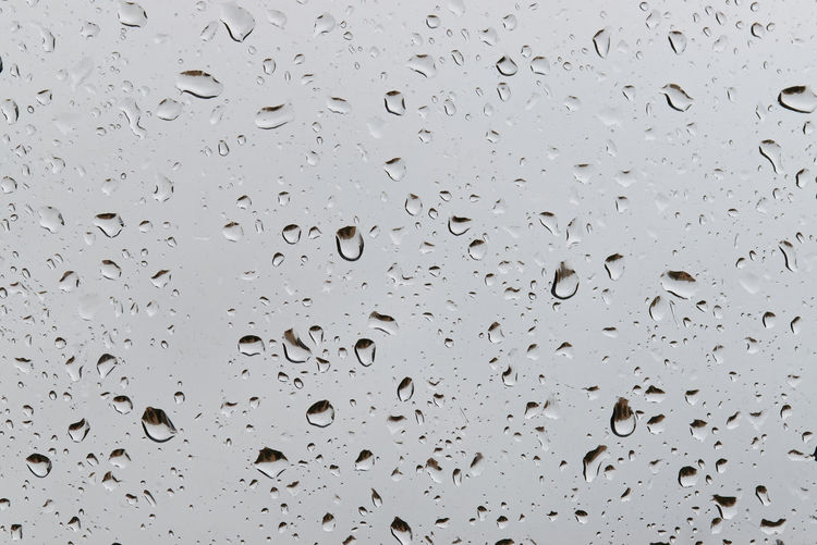 Water droplets condensed on transparent window. water rain drops.
