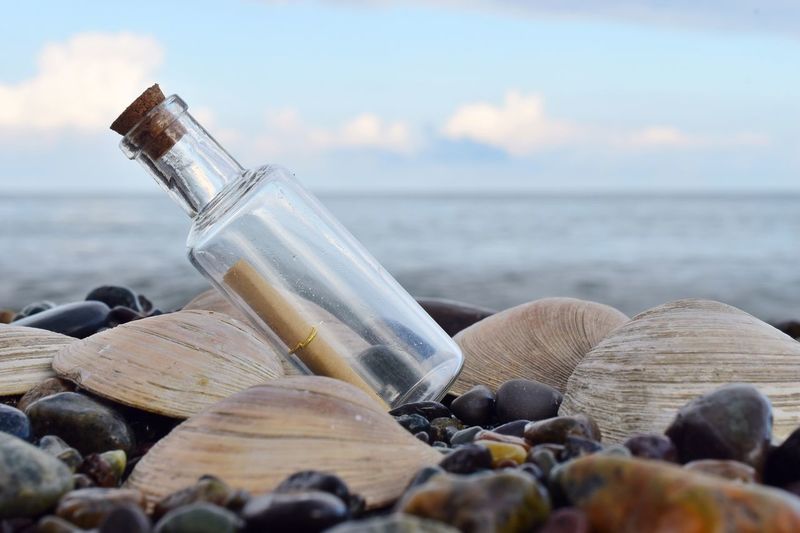 Close-up of bottle at beach