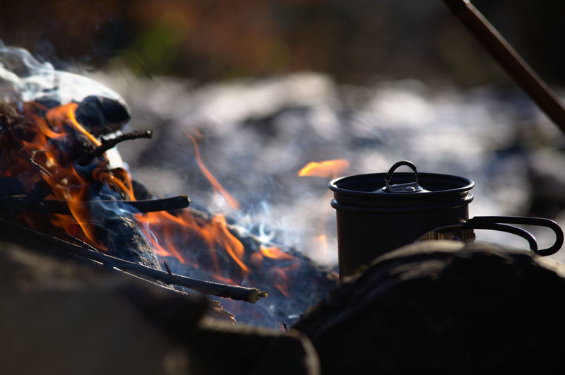 Close-up of pot on campfire