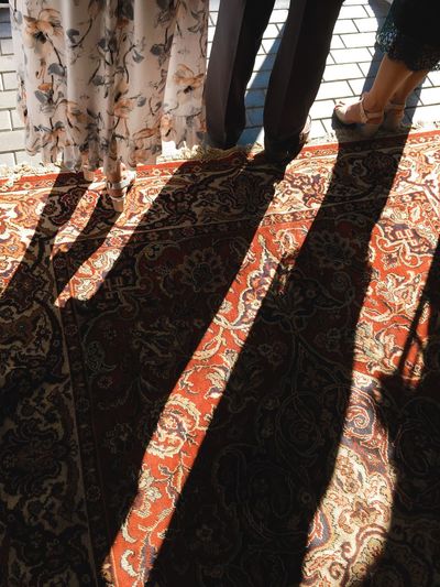 Low section of women standing on carpet