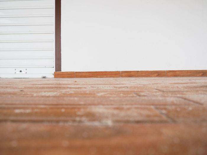 Surface level of wooden table against wall