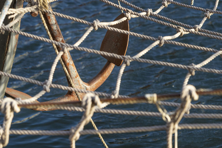 Close-up of anchor hanging on boat