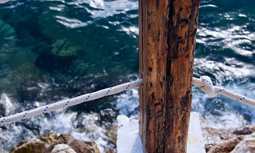 High angle view of wooden post in water