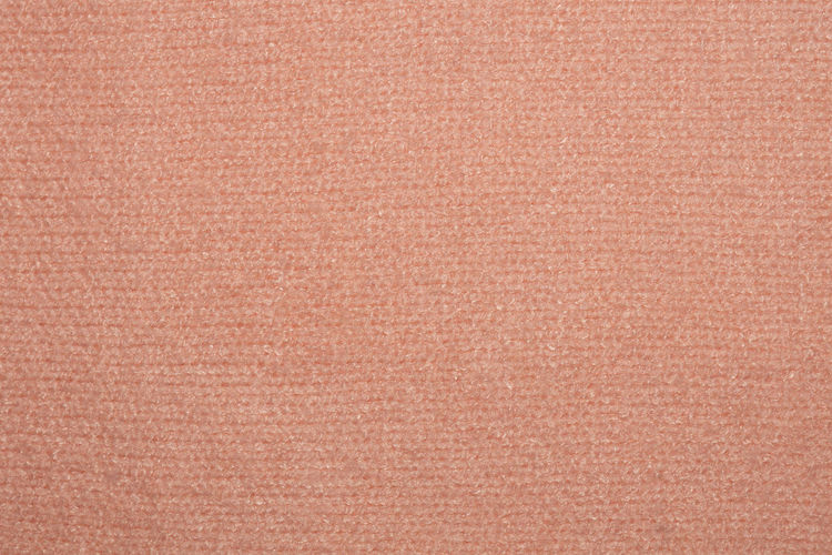 Close up photo of pink knitted sweater texture as abstract background.