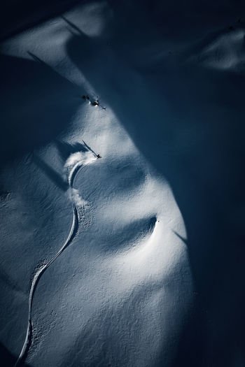Aerial photo of adult man backcountry powder skiing in the kootenays, b.c., canada