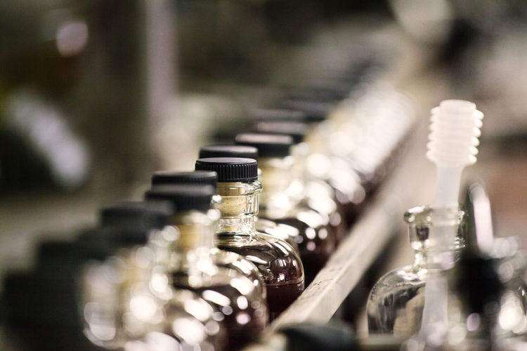 Close-up whiskey bottles in cider at distillery