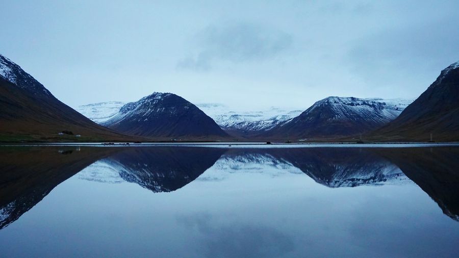 Scenic view of lake and mountains against sky