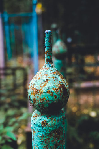 Close-up of rusty bottle