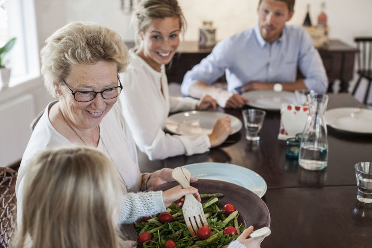 Multi-generation family having lunch at dining table