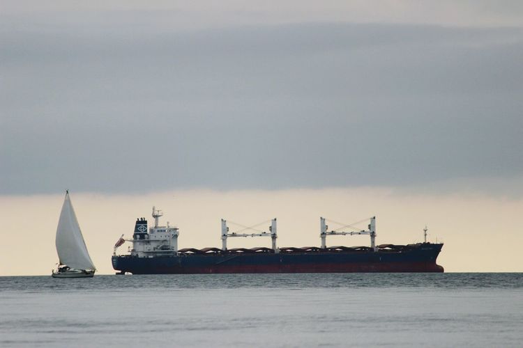 Ship sailing in sea against sky