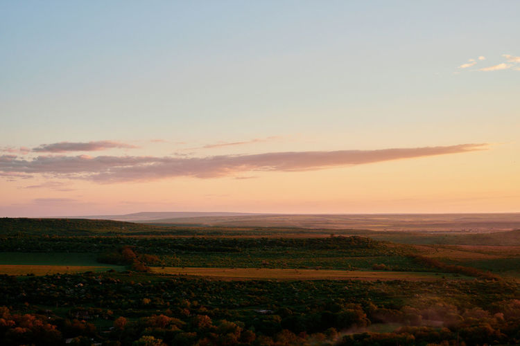 Scenic view of field against sky during sunset