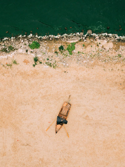 Aerial view of old boat on the sandy shore