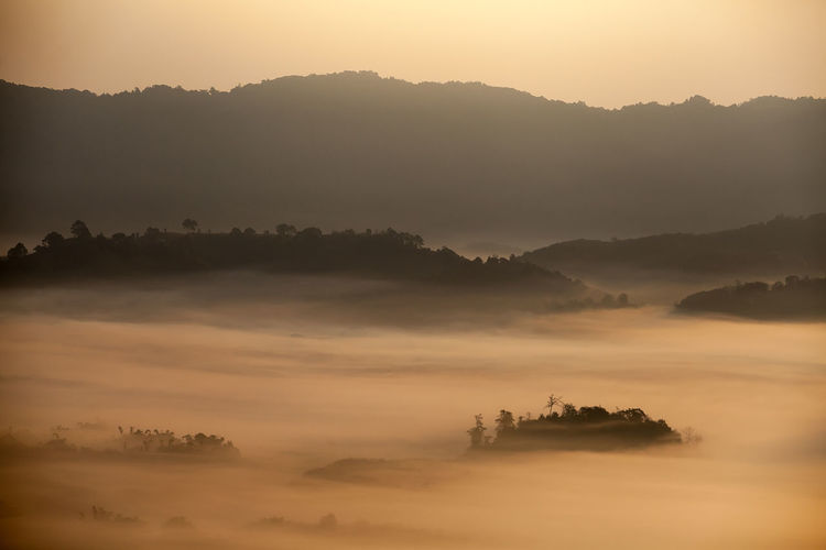 Scenic view of silhouette mountains against sky during sunset