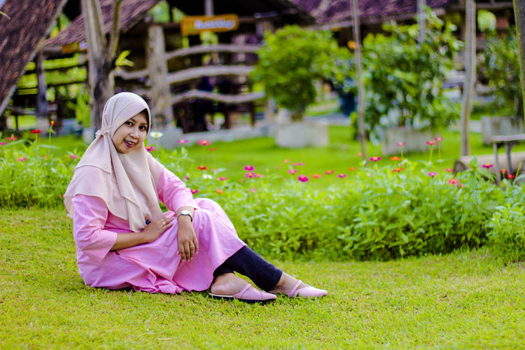Portrait of woman sitting on grass
