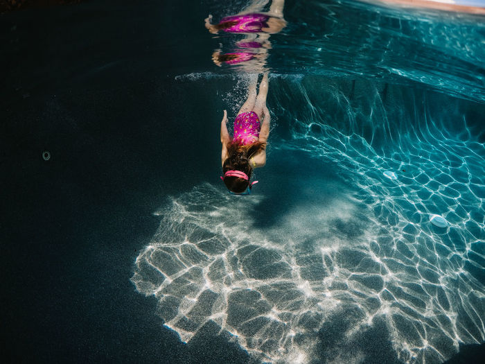 Girl diving into swimming pool