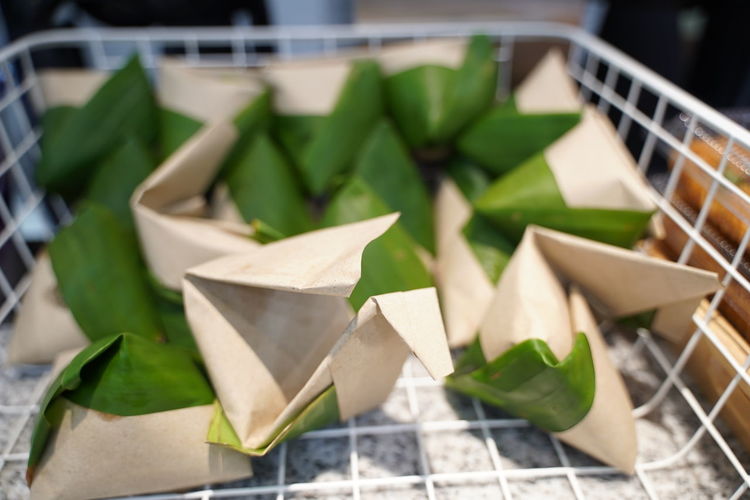 High angle view of nasi lemak wrapped with banana leaf and  paper